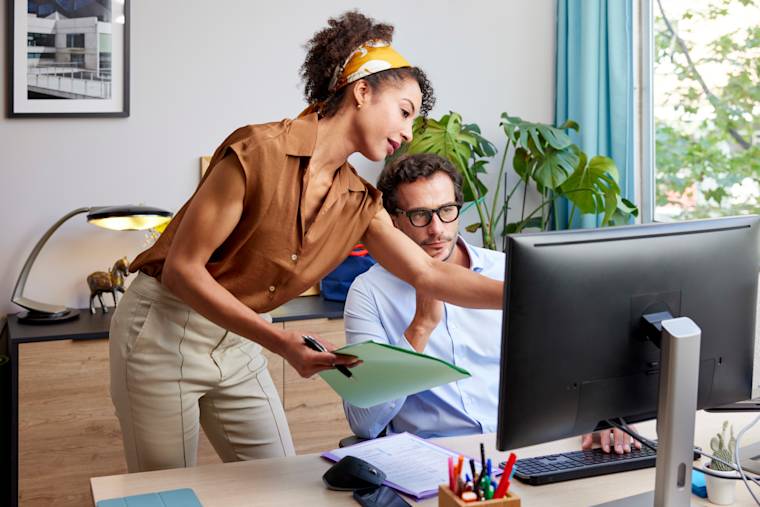 Marketers working at a desktop computer