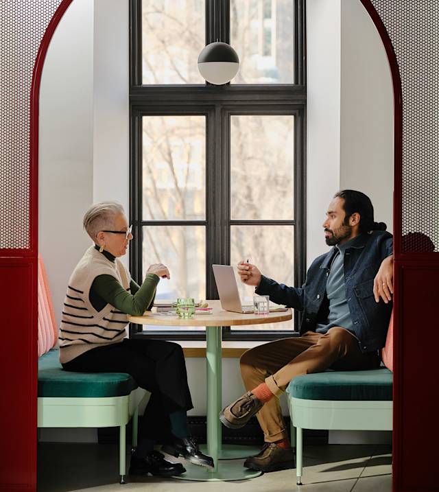 a woman and a man having a meeting in a cafe 