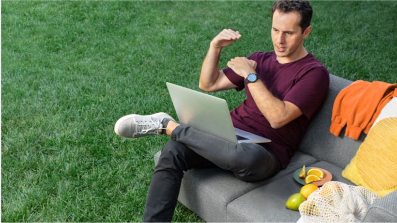 A man taking a video call from outside, gesturing as he talks through a website launch plan.