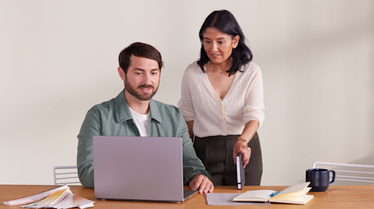 Two small-business owners learning how to send transactional emails with Mailchimp.